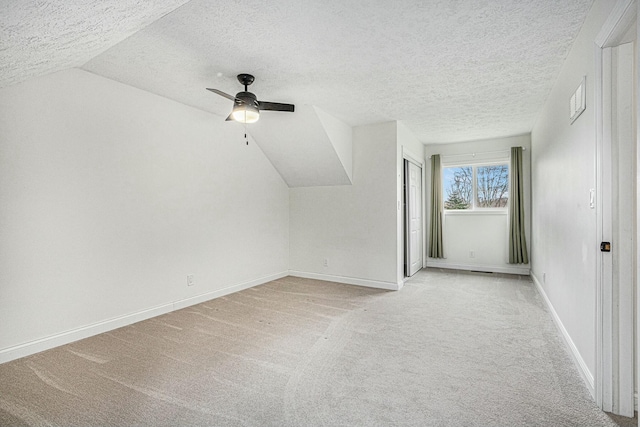 2569 Ridgewood Trl, Berrien Springs, MI 49103 - bonus room with vaulted ceiling, a ceiling fan, a textured ceiling, light carpet, and baseboards
