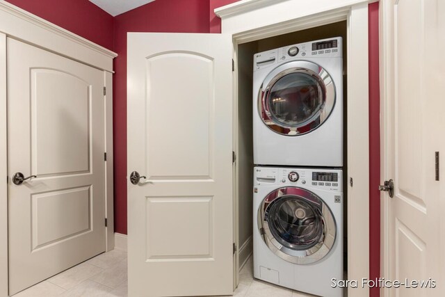 6501 Andres Xing Unit 14, Grandville, MI 49418 - washroom featuring light tile patterned flooring, stacked washer and dryer, and laundry area