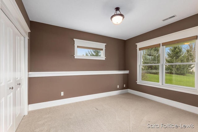 6501 Andres Xing Unit 14, Grandville, MI 49418 - spare room featuring a healthy amount of sunlight, visible vents, and carpet