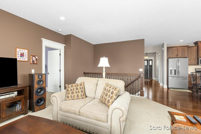 6501 Andres Xing Unit 14, Grandville, MI 49418 - living area with baseboards, arched walkways, dark wood-style floors, and recessed lighting