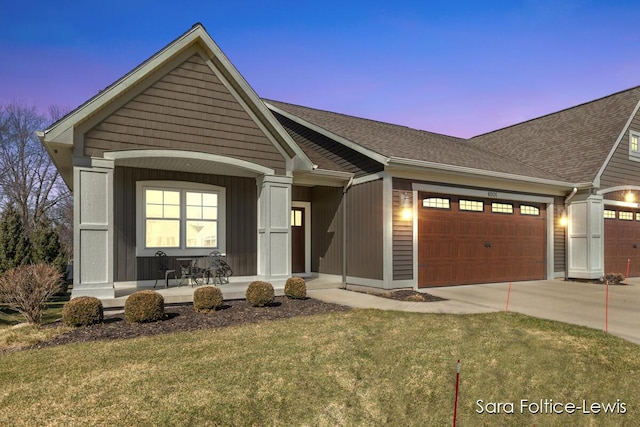 6501 Andres Xing Unit 14, Grandville, MI 49418 - view of front facade with a front lawn, a porch, concrete driveway, a garage, and a shingled roof