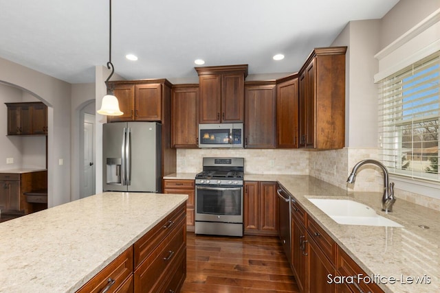 6501 Andres Xing Unit 14, Grandville, MI 49418 - kitchen with recessed lighting, light stone counters, a sink, dark wood-type flooring, and appliances with stainless steel finishes