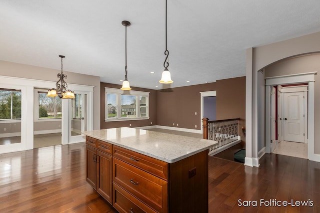 6501 Andres Xing Unit 14, Grandville, MI 49418 - kitchen with dark wood finished floors, a wealth of natural light, and hanging light fixtures
