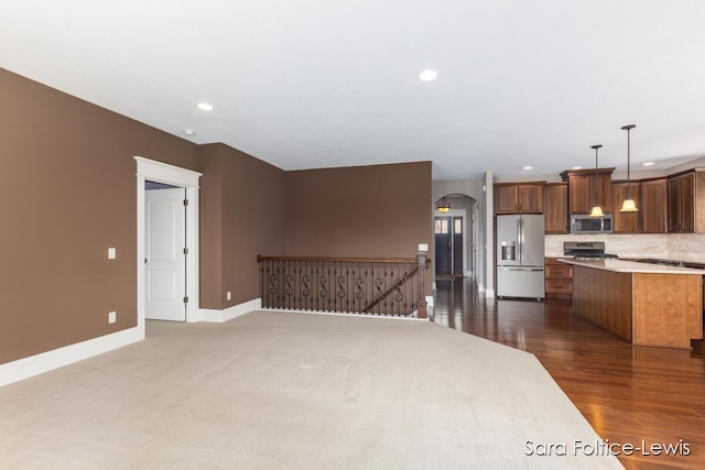 6501 Andres Xing Unit 14, Grandville, MI 49418 - interior space with recessed lighting, light countertops, baseboards, appliances with stainless steel finishes, and open floor plan