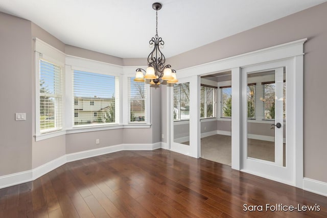 6501 Andres Xing Unit 14, Grandville, MI 49418 - unfurnished dining area with a chandelier, wood-type flooring, baseboards, and french doors