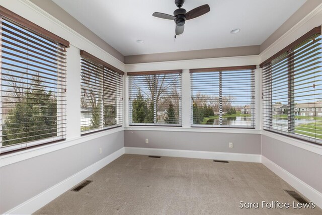 6501 Andres Xing Unit 14, Grandville, MI 49418 - unfurnished sunroom with carpet flooring, visible vents, and plenty of natural light