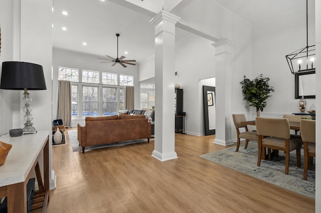2693 Sanctuary Dr, Stevensville, MI 49127 - living area with ceiling fan, a towering ceiling, and decorative columns