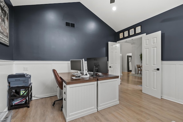 2693 Sanctuary Dr, Stevensville, MI 49127 - office featuring a wainscoted wall, ornate columns, visible vents, light wood-style flooring, and high vaulted ceiling