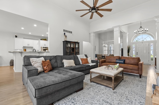 2693 Sanctuary Dr, Stevensville, MI 49127 - living room with plenty of natural light, visible vents, light wood finished floors, and ceiling fan with notable chandelier
