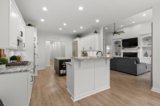 2693 Sanctuary Dr, Stevensville, MI 49127 - kitchen with recessed lighting, a ceiling fan, built in refrigerator, a peninsula, and white cabinetry