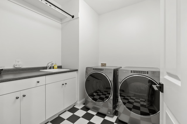 2693 Sanctuary Dr, Stevensville, MI 49127 - laundry room with washing machine and clothes dryer, tile patterned floors, cabinet space, and a sink