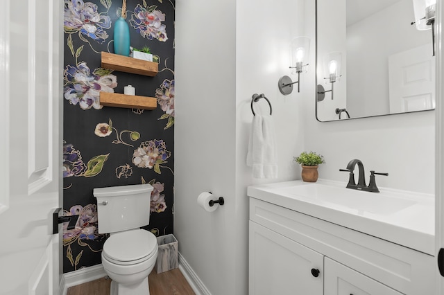 2693 Sanctuary Dr, Stevensville, MI 49127 - half bathroom featuring baseboards, wood finished floors, toilet, and vanity