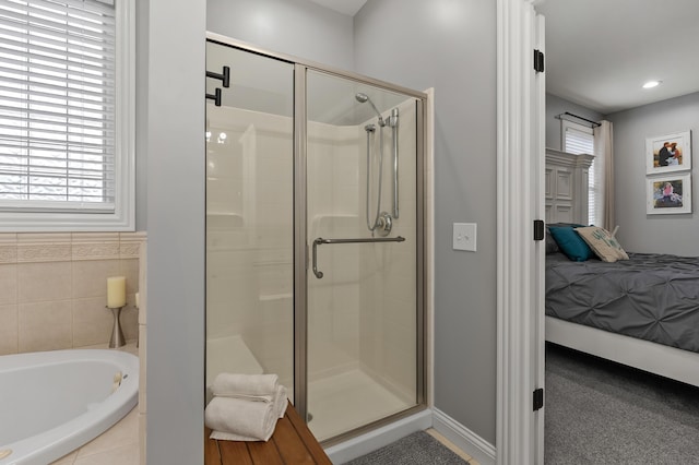 2693 Sanctuary Dr, Stevensville, MI 49127 - ensuite bathroom featuring a shower stall, a garden tub, baseboards, and ensuite bathroom