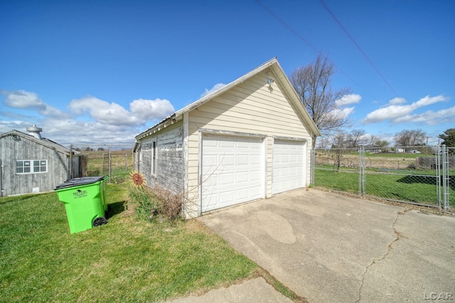 detached garage featuring fence