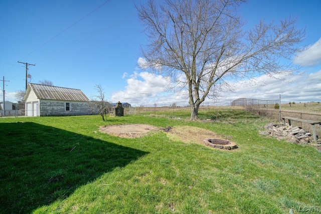 view of yard featuring a fire pit and fence
