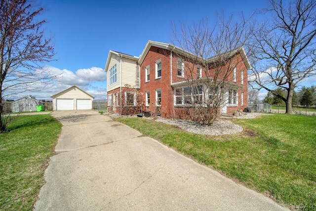 view of property exterior featuring brick siding, an outbuilding, a yard, and a garage