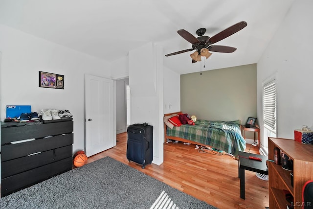 bedroom featuring wood finished floors, baseboards, and ceiling fan