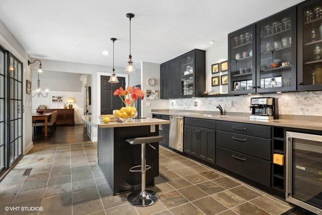 16191 4th Ln, Union Pier, MI 49129 - interior space with dark cabinetry, wine cooler, stainless steel dishwasher, and tasteful backsplash