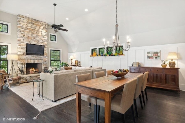 16191 4th Ln, Union Pier, MI 49129 - dining room featuring high vaulted ceiling, a stone fireplace, a decorative wall, hardwood / wood-style flooring, and ceiling fan with notable chandelier