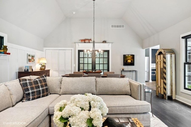16191 4th Ln, Union Pier, MI 49129 - living area featuring a notable chandelier, visible vents, high vaulted ceiling, and dark wood-style floors