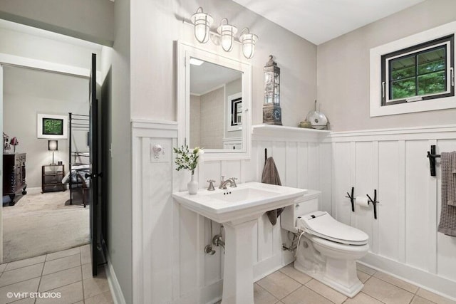 16191 4th Ln, Union Pier, MI 49129 - bathroom with a decorative wall, tile patterned floors, wainscoting, and toilet