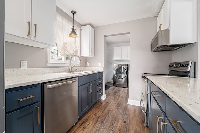 kitchen featuring appliances with stainless steel finishes, a sink, white cabinetry, washing machine and dryer, and dark wood-type flooring