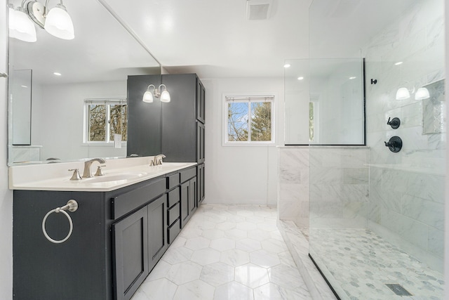bathroom with plenty of natural light, a walk in shower, tile patterned floors, and double vanity