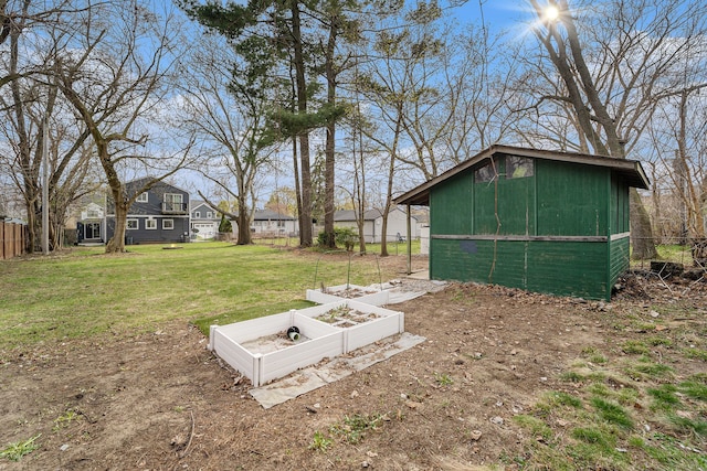 view of yard featuring a garden and an outbuilding