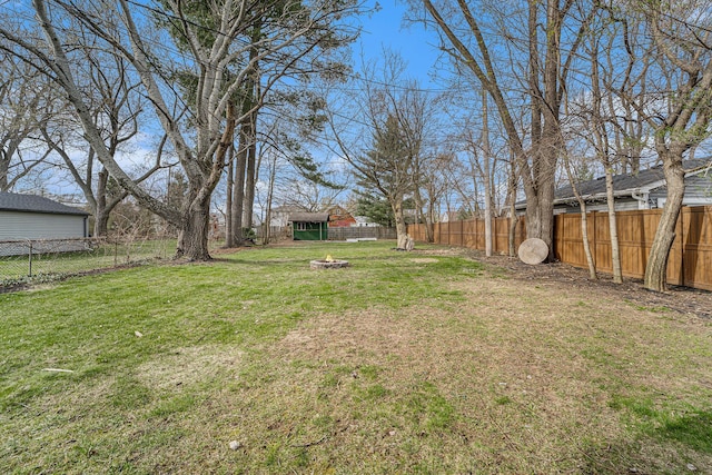 view of yard with a fire pit