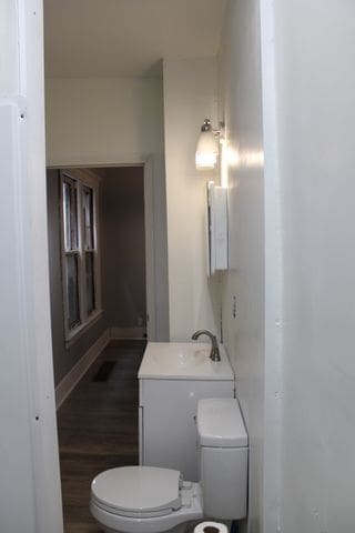 5815 Cadillac Ave, Detroit, MI 48213 - bathroom with toilet and wood finished floors