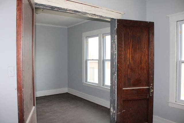 5815 Cadillac Ave, Detroit, MI 48213 - unfurnished room with baseboards, wood finished floors, and ornamental molding