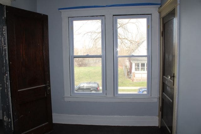 5815 Cadillac Ave, Detroit, MI 48213 - doorway to outside featuring baseboards
