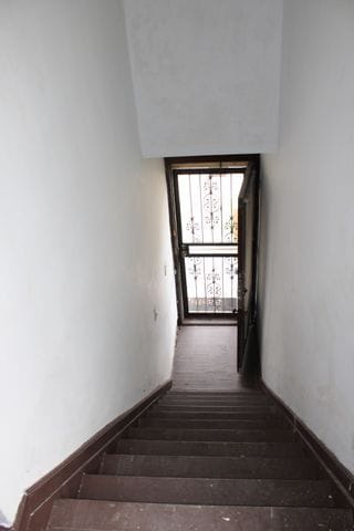 5815 Cadillac Ave, Detroit, MI 48213 - staircase with baseboards and hardwood / wood-style flooring