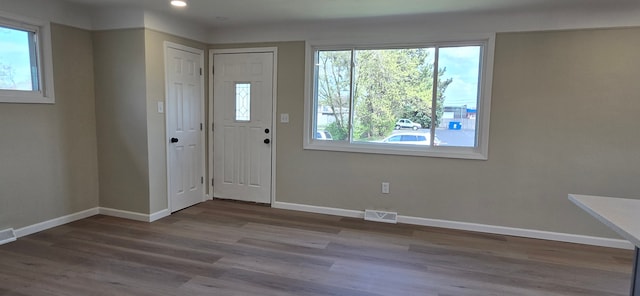 foyer with recessed lighting, wood finished floors, visible vents, and baseboards