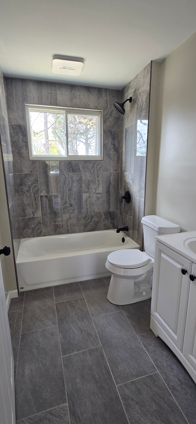 full bathroom with tile patterned floors, bathing tub / shower combination, a wealth of natural light, and toilet