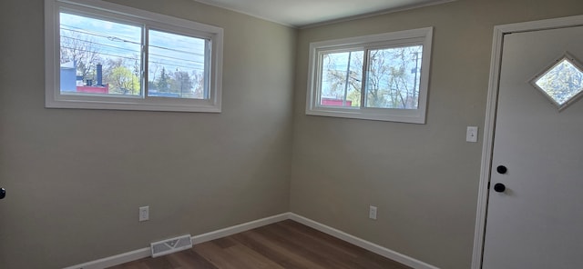 entryway featuring baseboards, visible vents, and dark wood finished floors