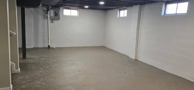 basement featuring electric panel and a healthy amount of sunlight