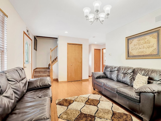living room with a chandelier, wood finished floors, stairs, and recessed lighting