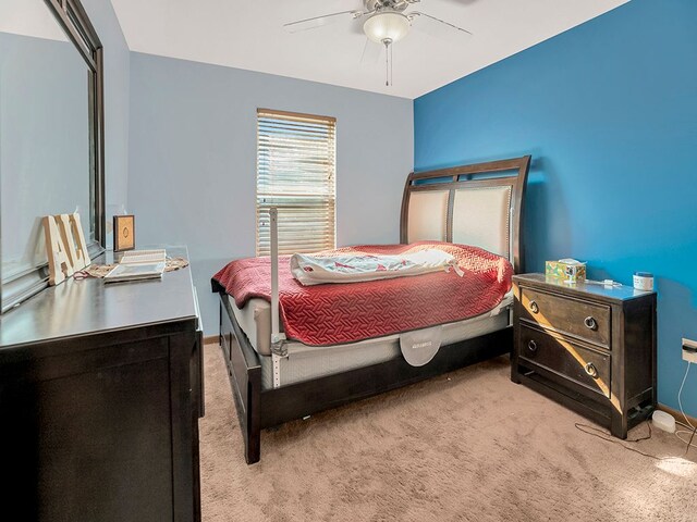 bedroom featuring carpet floors, a ceiling fan, and baseboards