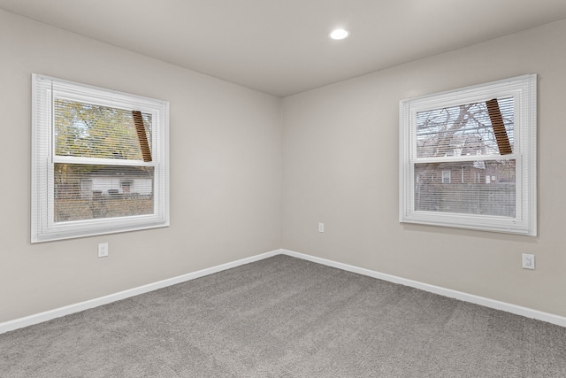 carpeted empty room with recessed lighting and baseboards