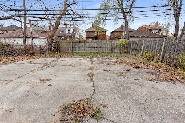 view of yard with a fenced backyard, a residential view, and a patio