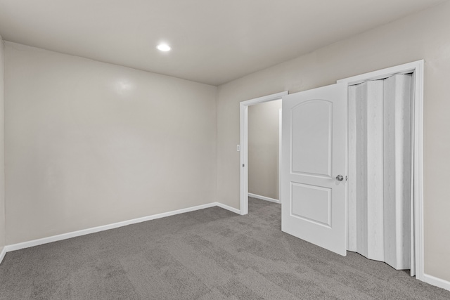 unfurnished bedroom with recessed lighting, carpet floors, a closet, and baseboards