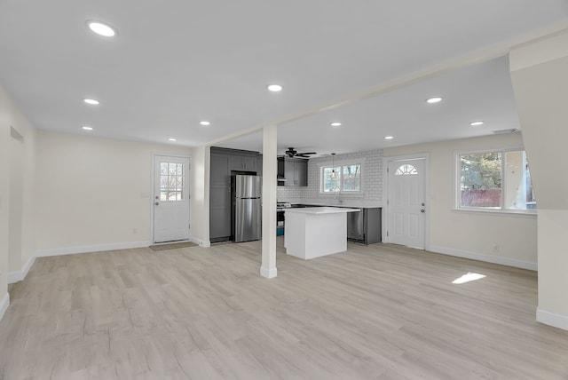 17511 Castle St, Roseville, MI 48066 - unfurnished living room featuring plenty of natural light, light wood-style flooring, and baseboards