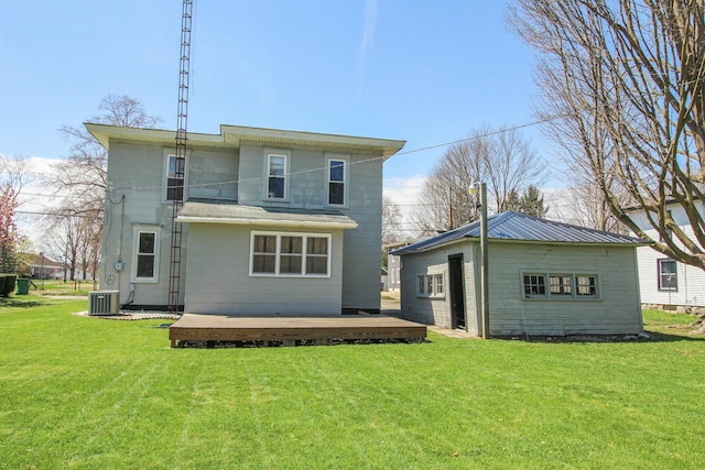 rear view of property with a wooden deck, a lawn, and central AC unit