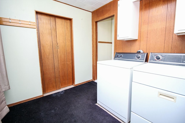 clothes washing area with cabinet space and independent washer and dryer