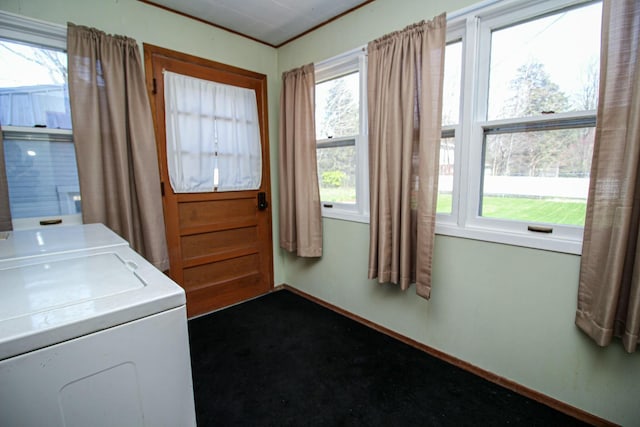 laundry room with separate washer and dryer, baseboards, dark colored carpet, and laundry area