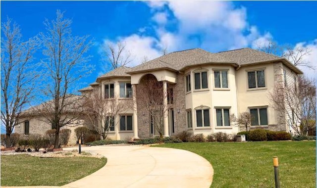 view of building exterior with curved driveway