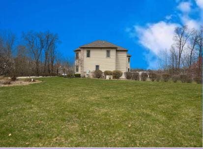 rear view of property with a yard