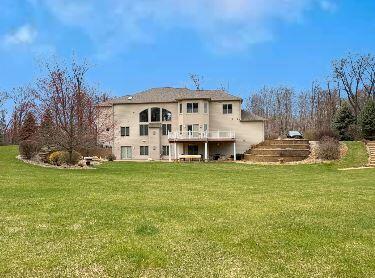 rear view of house featuring a lawn