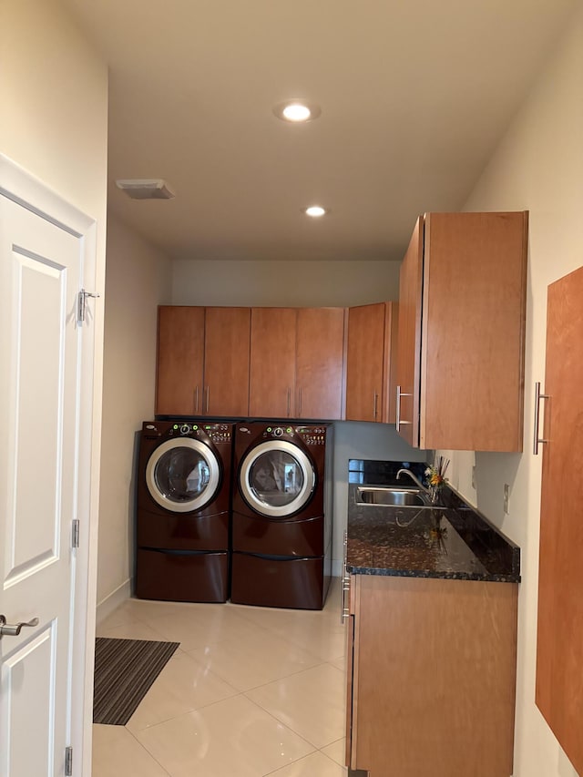 laundry room featuring recessed lighting, light tile patterned floors, washing machine and dryer, a sink, and cabinet space